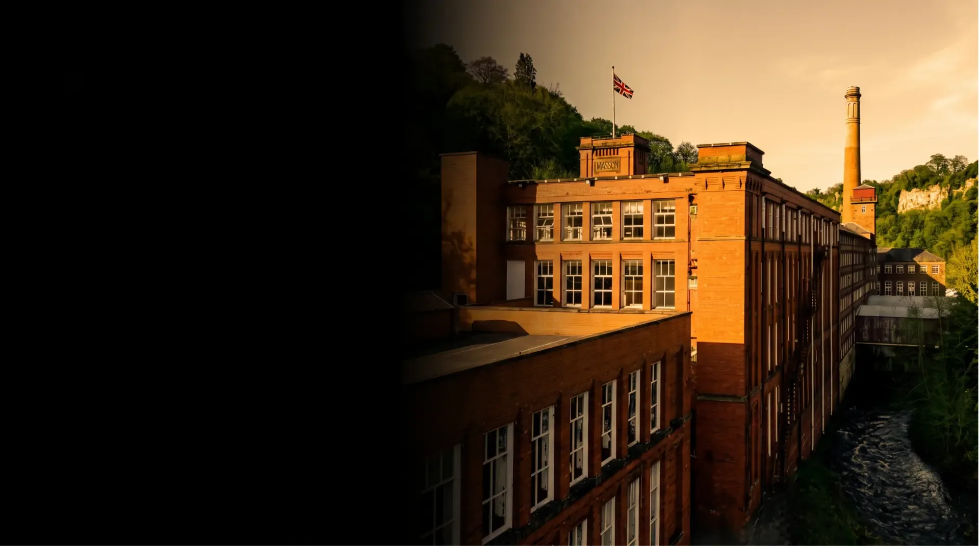 Masson Mills and its riverside façade at sunset
