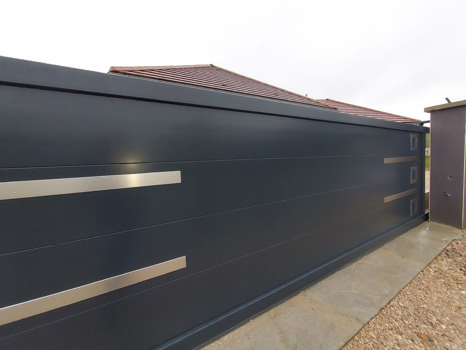 Bespoke aluminium sliding gate installed at a driveway entrance